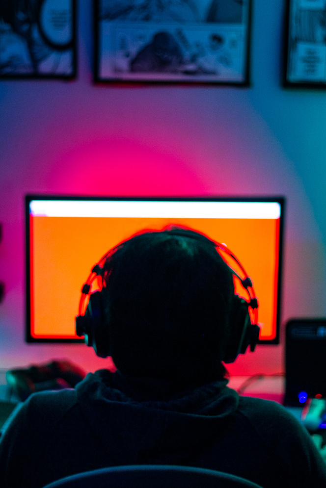Man with Headphones Playing Computer Game