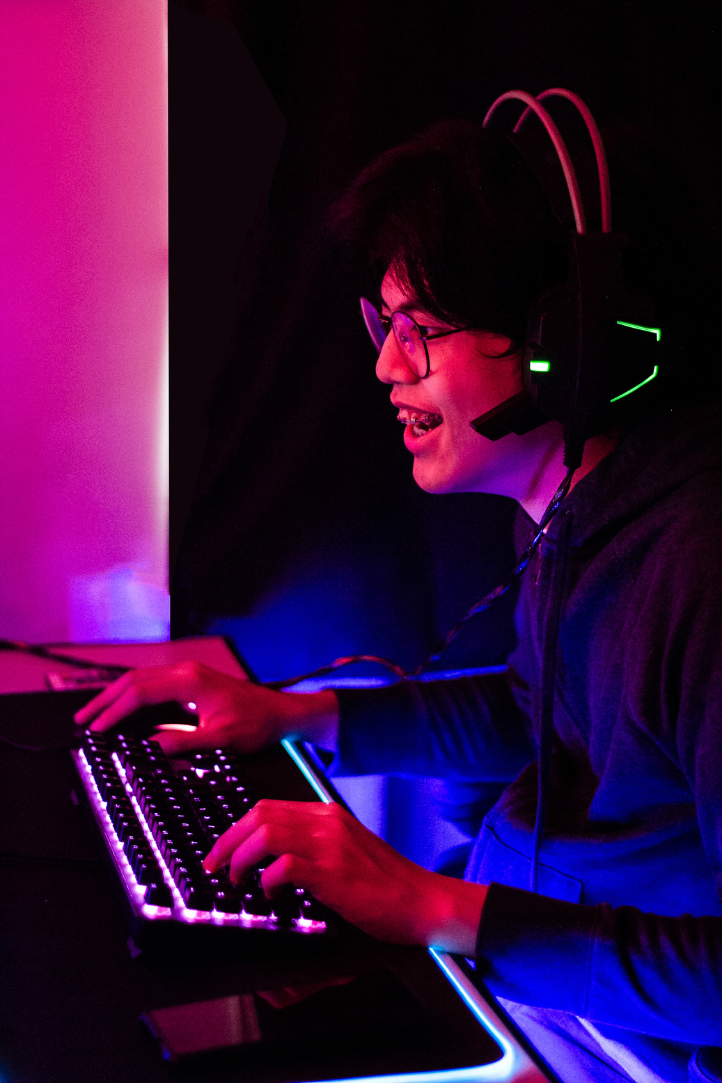 Smiling Man with Eyeglasses Playing Computer Game